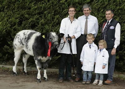 Barbra Van Rie with Matthew and Jacqueline McKinney first in the heifer class with judge Wilfred Lomas and Harold McKee secretary